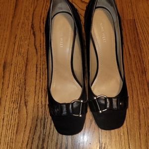 Black suede pumps with side buckle.